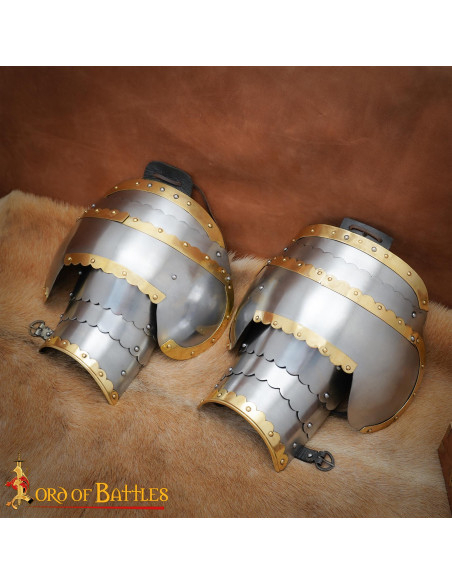 Medieval steel pauldrons with brass...
