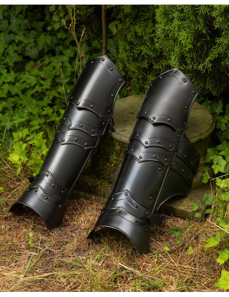 Medieval greaves in blackened steel....