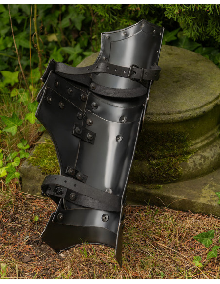 Medieval greaves in blackened steel....