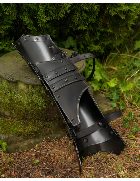 Medieval greaves in blackened steel....