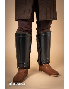 Medieval warrior greaves in burnished steel