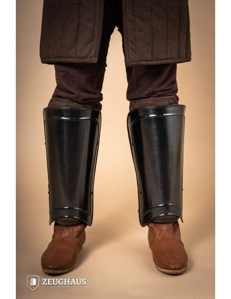 Medieval warrior greaves in burnished...