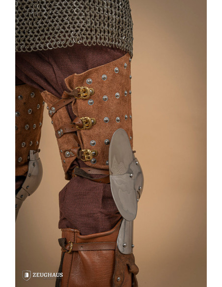 Medieval leg armor in leather and steel