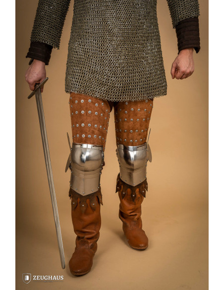 Medieval leg armor in leather and steel