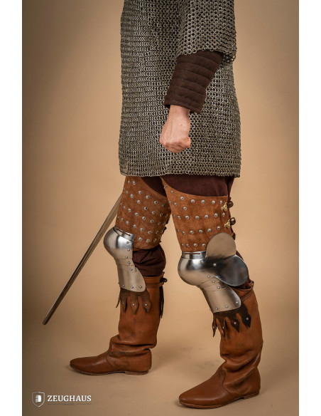 Medieval leg armor in leather and steel