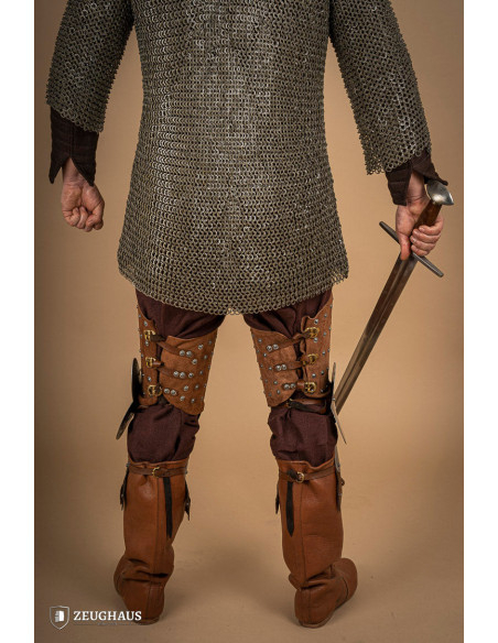 Medieval leg armor in leather and steel