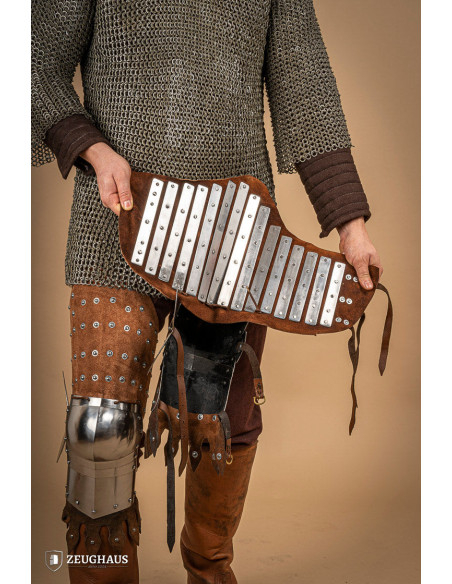 Medieval leg armor in leather and steel