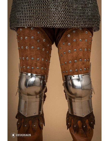 Medieval leg armor in leather and steel