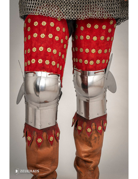 Medieval leg armor in steel and red...