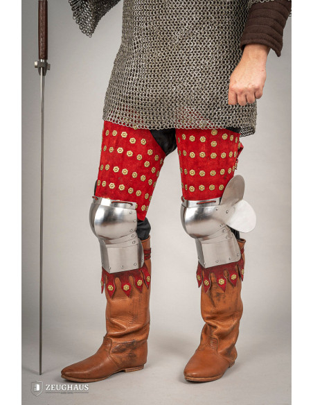 Medieval leg armor in steel and red...