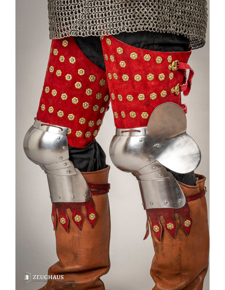 Medieval leg armor in steel and red...