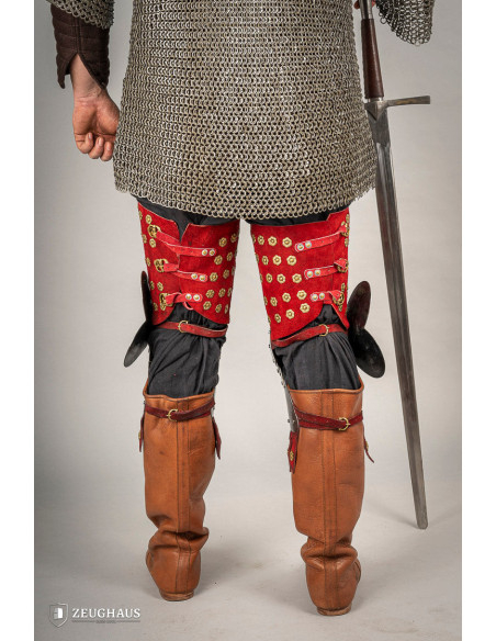 Medieval leg armor in steel and red...