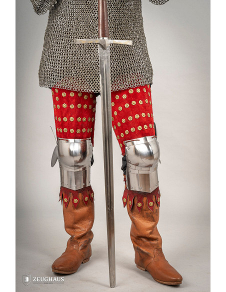 Medieval leg armor in steel and red...