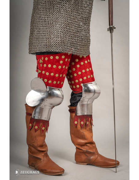 Medieval leg armor in steel and red...