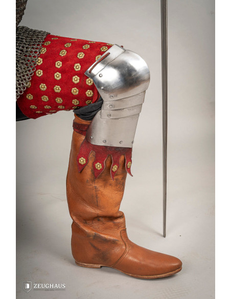 Medieval leg armor in steel and red...