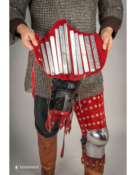 Medieval leg armor in steel and red...