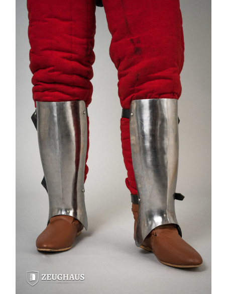 Medieval greaves in polished steel,...